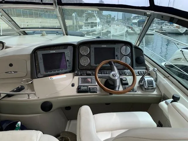 The Boardroom Yacht Photos Pics 2008 Sea Ray Sundancer helm with dual displays and wooden steering wheel at marina.