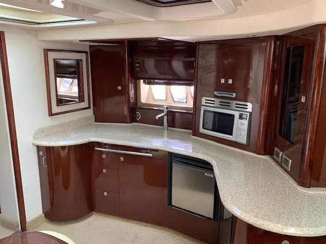 The Boardroom Yacht Photos Pics Luxurious 2008 Sea Ray Sundancer yacht kitchen with modern appliances and elegant wood cabinetry.