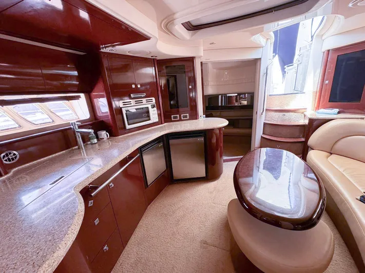 The Boardroom Yacht Photos Pics Luxurious 2008 Sea Ray Sundancer yacht interior with modern kitchen and elegant seating area.