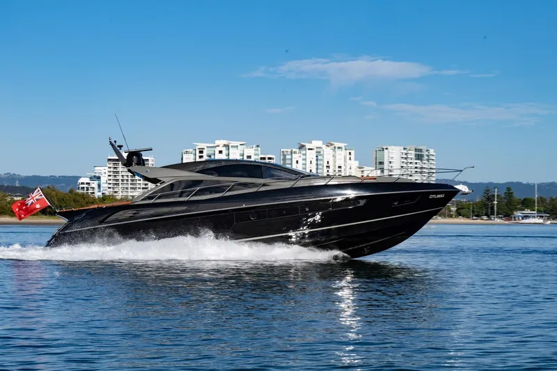 Zaza Yacht Photos Pics 2013 Sunseeker Predator 68 yacht cruising on water with cityscape background.