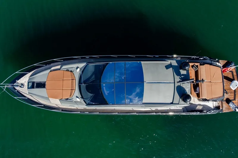 Zaza Yacht Photos Pics Aerial view of 2013 Sunseeker Predator 68 yacht on green water.