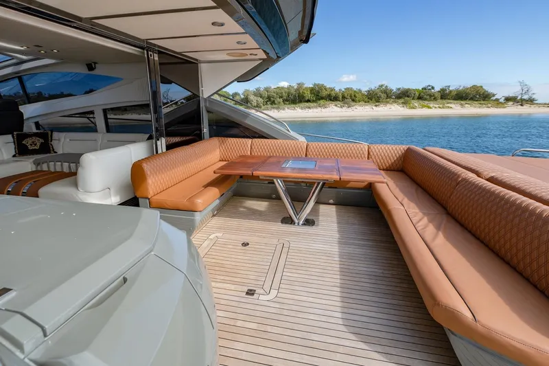 Zaza Yacht Photos Pics Luxurious 2013 Sunseeker Predator 68 yacht with elegant outdoor seating and scenic water view.