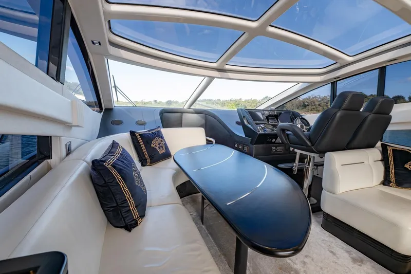 Zaza Yacht Photos Pics Luxurious interior of 2013 Sunseeker Predator 68 yacht with plush seating and panoramic windows.