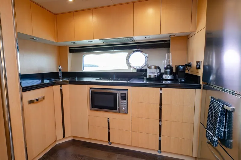 Zaza Yacht Photos Pics Luxurious kitchen interior of 2013 Sunseeker Predator 68 yacht, featuring modern appliances and sleek design.