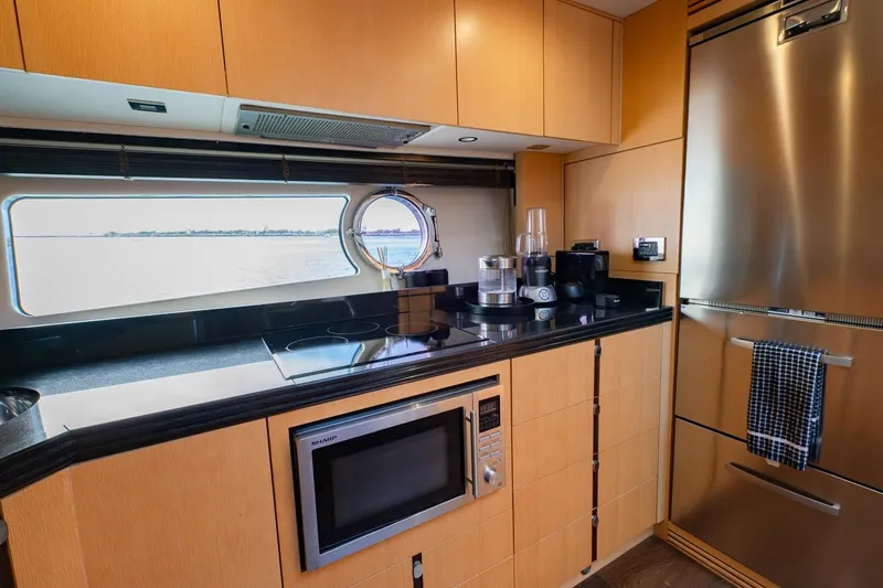 Zaza Yacht Photos Pics Modern kitchen interior on 2013 Sunseeker Predator 68 yacht, featuring sleek appliances and ocean view.