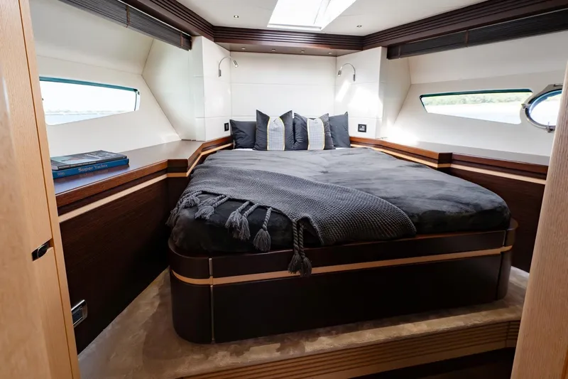 Zaza Yacht Photos Pics Luxurious bedroom in 2013 Sunseeker Predator 68 yacht, featuring elegant bedding and modern design.