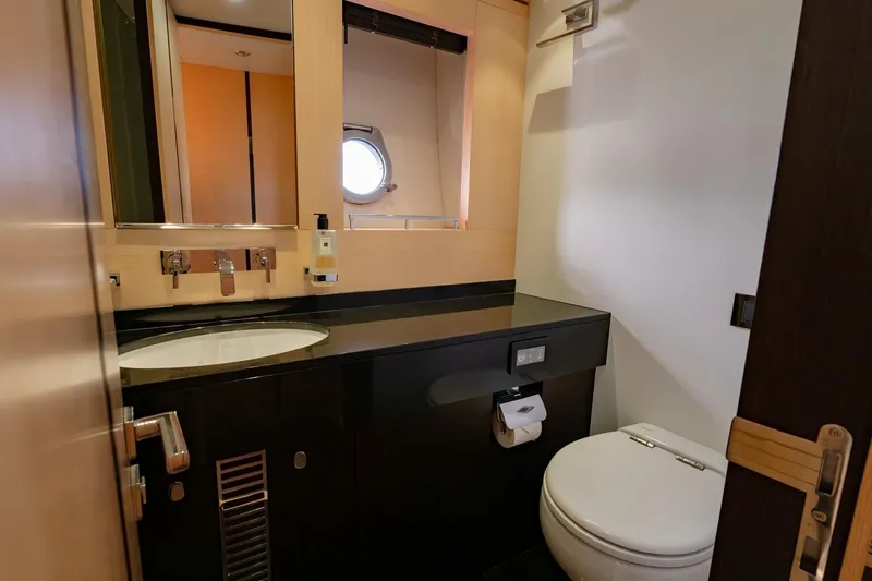 Zaza Yacht Photos Pics Luxurious bathroom in 2013 Sunseeker Predator 68 yacht, featuring modern fixtures and porthole window.