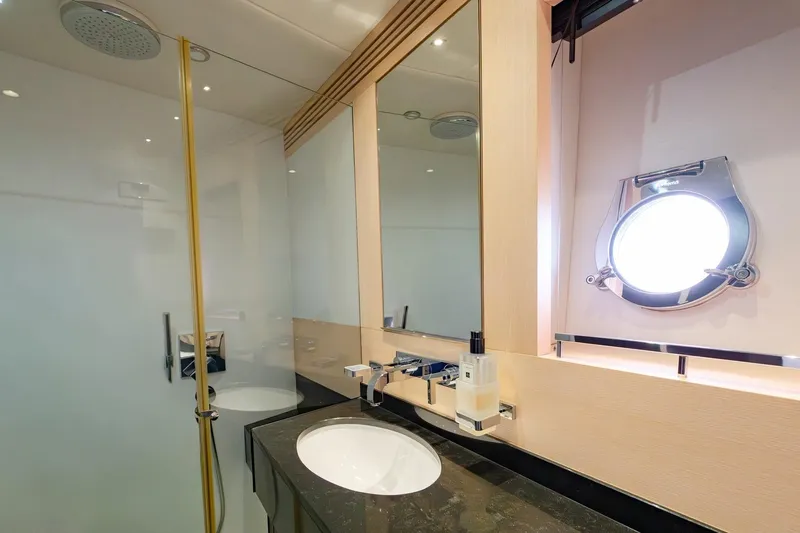 Zaza Yacht Photos Pics Luxurious bathroom in 2013 Sunseeker Predator 68 yacht, featuring modern fixtures and porthole window.