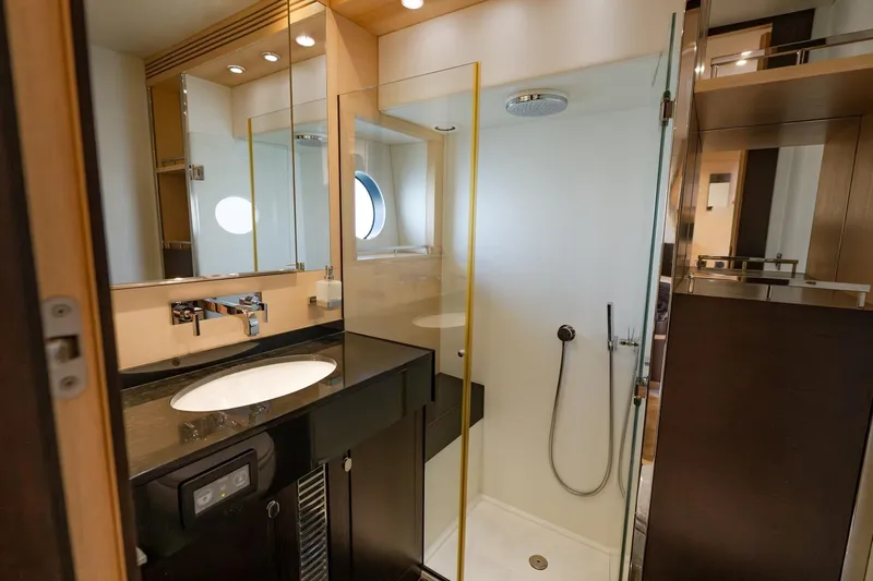 Zaza Yacht Photos Pics Luxurious bathroom in 2013 Sunseeker Predator 68 yacht with modern fixtures and glass shower.