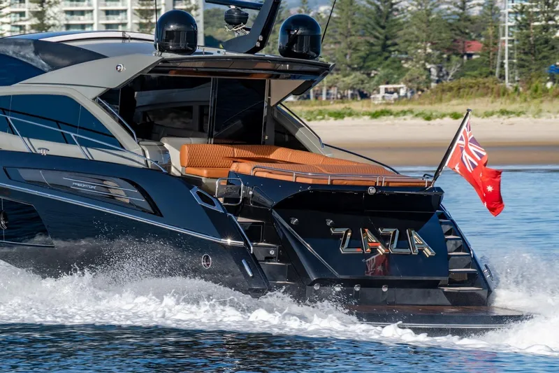 Zaza Yacht Photos Pics 2013 Sunseeker Predator 68 yacht cruising with flag, sleek design, and luxurious seating.