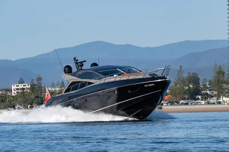 Zaza Yacht Photos Pics 2013 Sunseeker Predator 68 yacht cruising on water with scenic mountain backdrop.