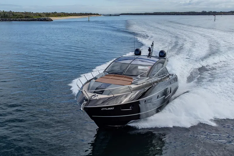 Zaza Yacht Photos Pics 2013 Sunseeker Predator 68 yacht cruising on open water, showcasing sleek design and luxury.