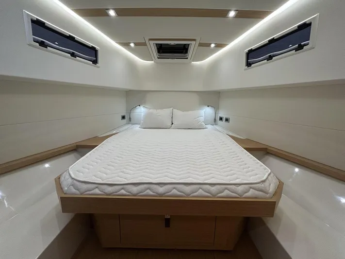 M/y Wavemoji Yacht Photos Pics Luxurious cabin interior of 2022 Pardo Yachts 38 with modern bedding and ambient lighting.