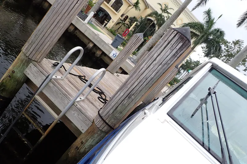  Yacht Photos Pics Docked 2023 Formula 380 Super Sport Crossover OB near waterfront with palm trees.