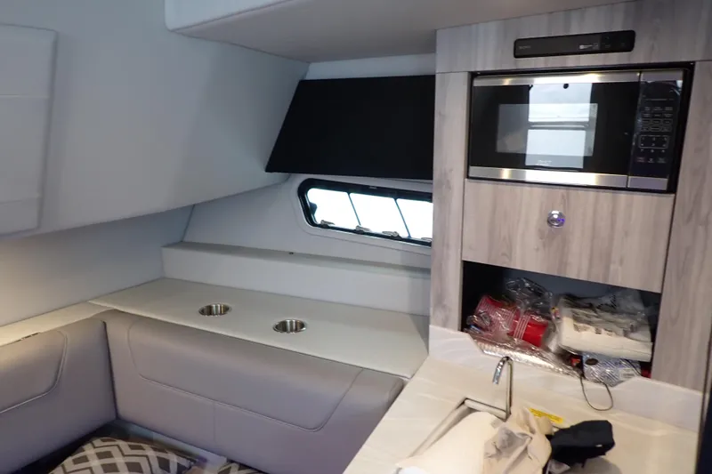  Yacht Photos Pics 2023 Formula 380 Super Sport Crossover OB interior with microwave and seating area.