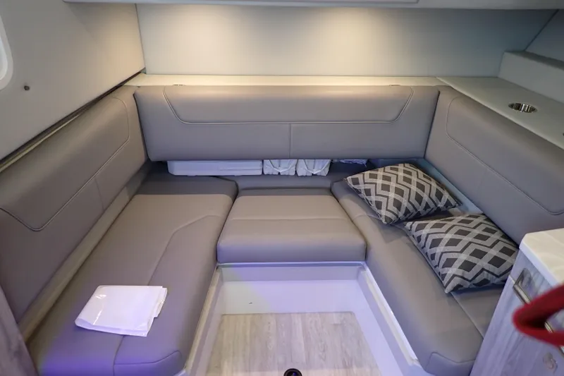  Yacht Photos Pics 2023 Formula 380 Super Sport Crossover OB interior with gray seating and patterned cushions.