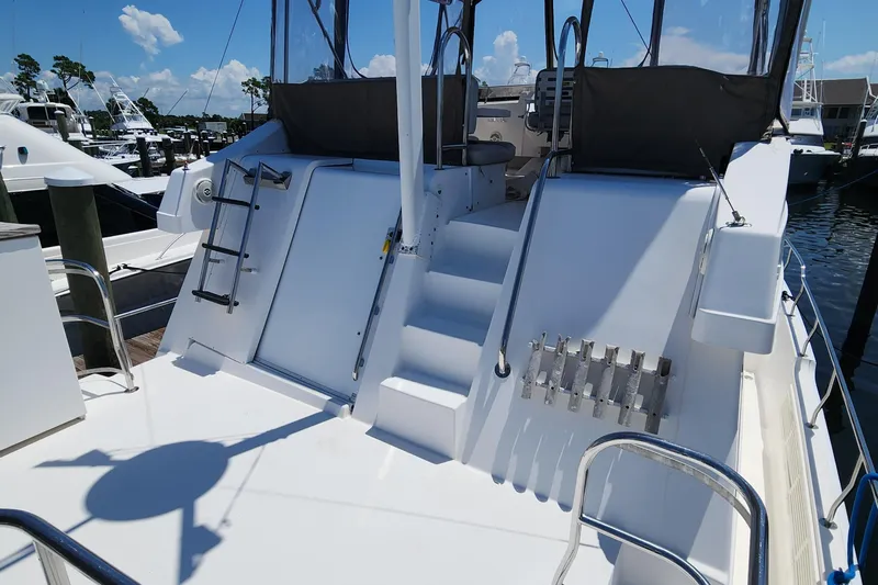  Yacht Photos Pics 2003 Mainship 43 Trawler Aft Cabin with spacious deck and ladder, docked at marina.