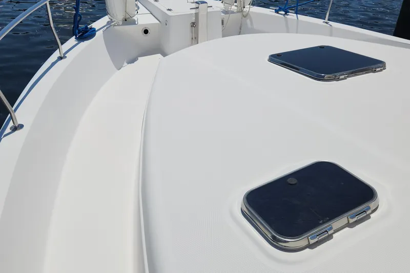  Yacht Photos Pics 2003 Mainship 43 Trawler Aft Cabin deck with hatches, railing, and water view.