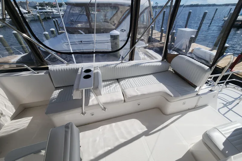  Yacht Photos Pics 2003 Mainship 43 Trawler Aft Cabin interior with white seating and cup holders.