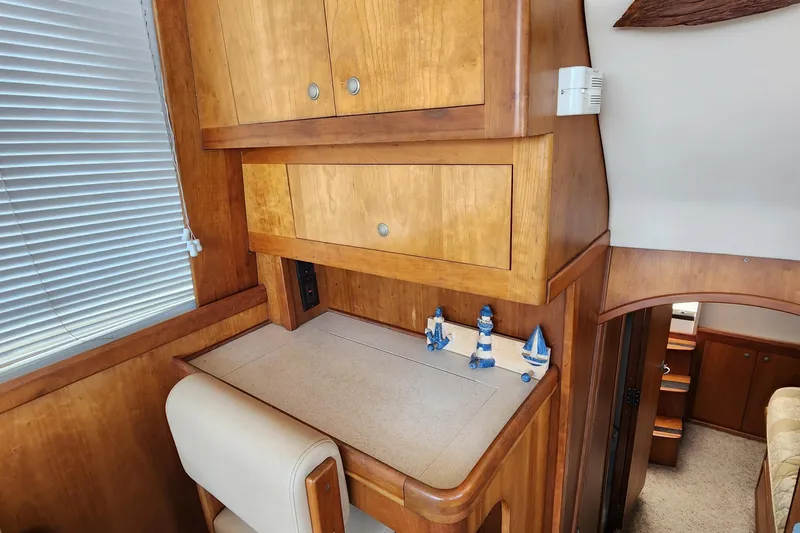  Yacht Photos Pics 2003 Mainship 43 Trawler Aft Cabin interior with wooden cabinetry and nautical decor.