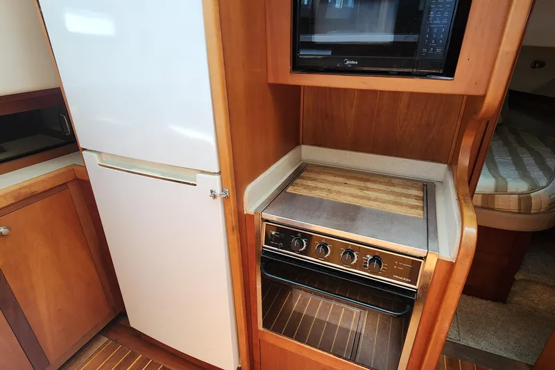  Yacht Photos Pics 2003 Mainship 43 Trawler Aft Cabin kitchen with fridge, stove, and microwave.