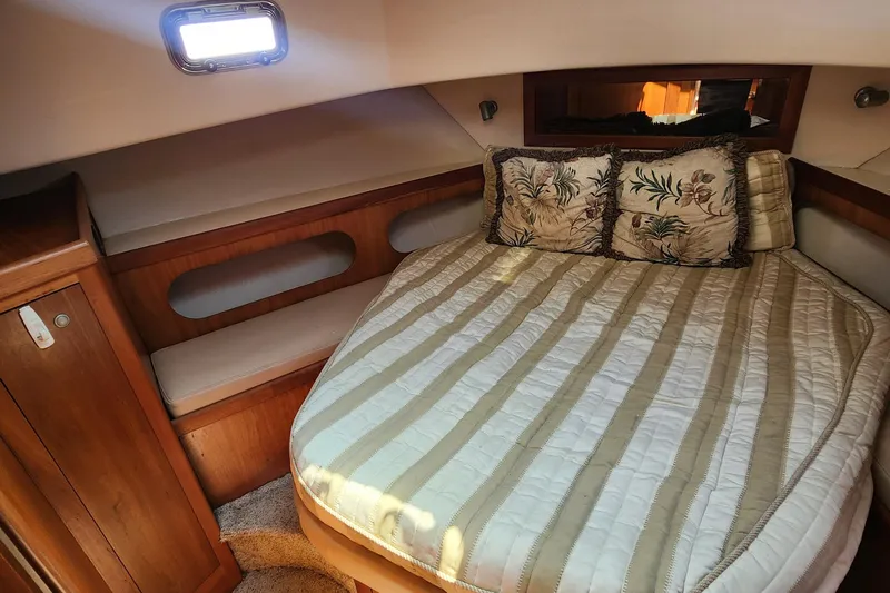  Yacht Photos Pics Cozy cabin interior of 2003 Mainship 43 Trawler Aft Cabin with striped bedding.