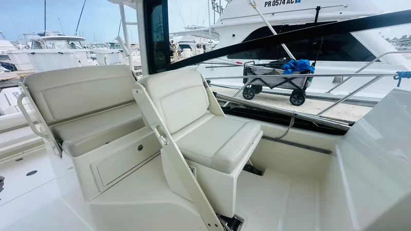  Yacht Photos Pics 2021 Boston Whaler 325 Conquest interior seating area at a marina.