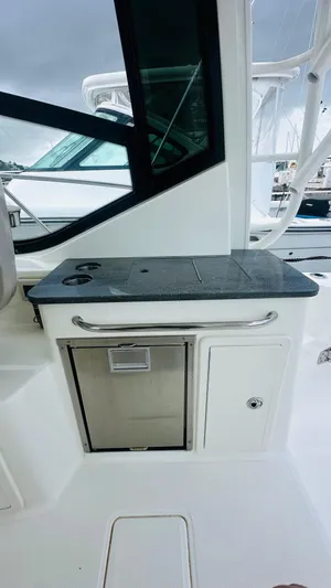  Yacht Photos Pics 2021 Boston Whaler 325 Conquest boat interior with countertop and storage.