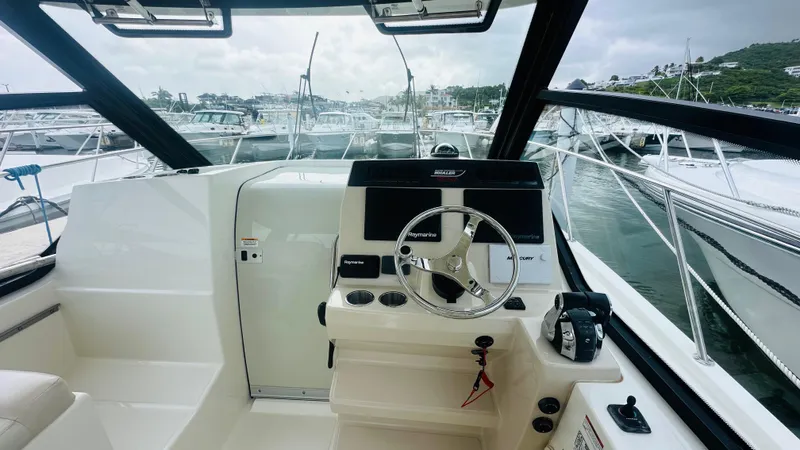  Yacht Photos Pics 2021 Boston Whaler 325 Conquest helm with modern controls and marina view.