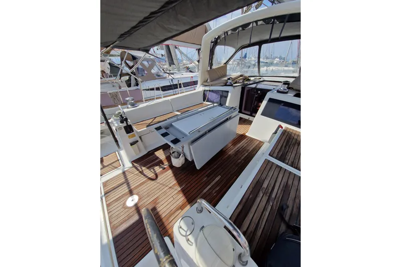 Yacht Photos Pics 2014 Beneteau Oceanis 48 yacht cockpit with wooden deck and modern amenities.