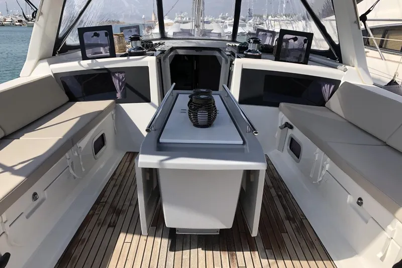  Yacht Photos Pics Spacious cockpit of 2014 Beneteau Oceanis 48 yacht with seating and table.