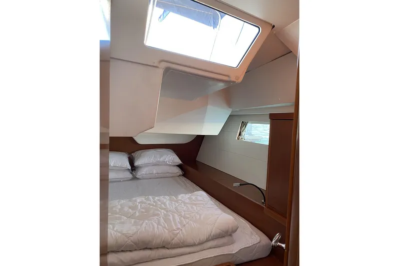  Yacht Photos Pics Cozy cabin interior of 2014 Beneteau Oceanis 48 yacht with skylight and bedding.