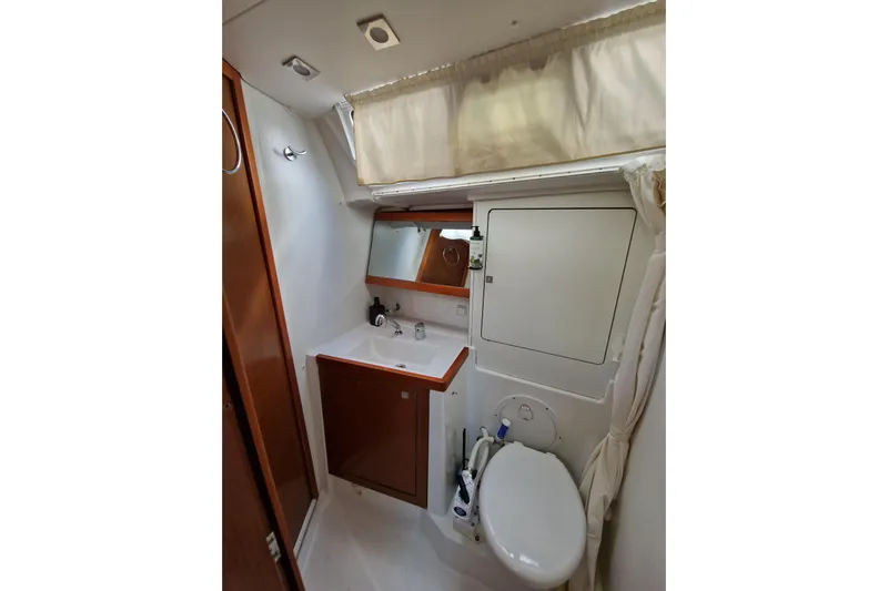  Yacht Photos Pics Bathroom interior of 2014 Beneteau Oceanis 48 yacht, featuring sink and toilet.