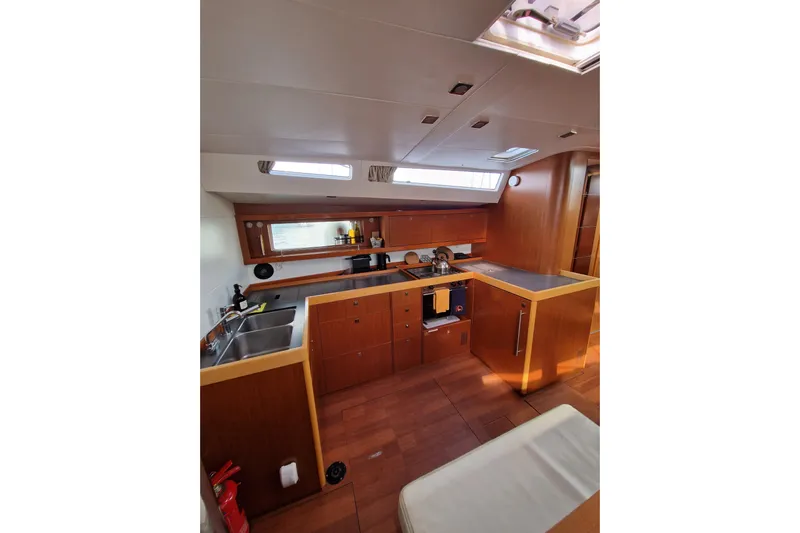  Yacht Photos Pics Interior of 2014 Beneteau Oceanis 48 yacht, featuring a modern kitchen with wood finish.