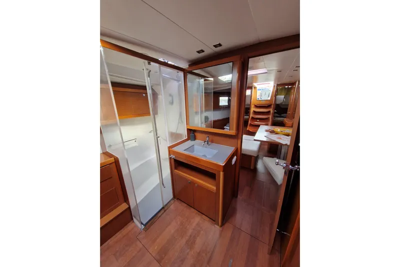  Yacht Photos Pics Interior of 2014 Beneteau Oceanis 48 yacht, featuring a modern bathroom and wooden finishes.