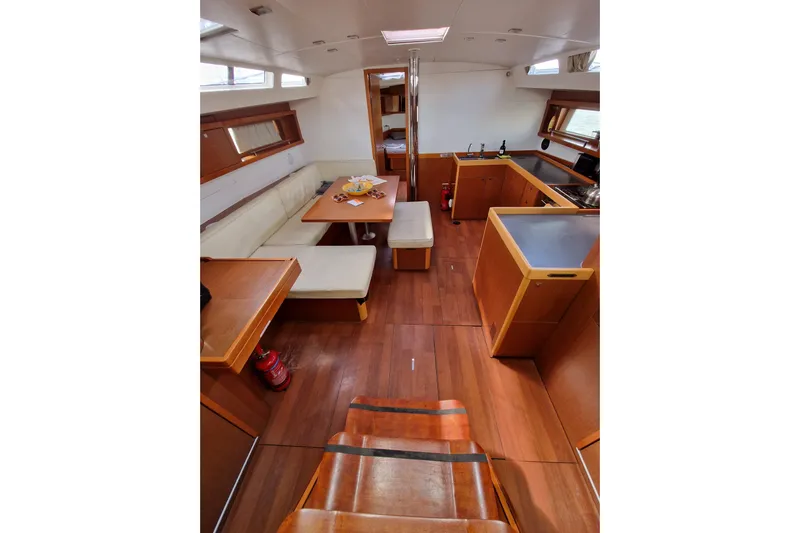  Yacht Photos Pics Interior of 2014 Beneteau Oceanis 48 yacht with wood finish and cozy seating area.