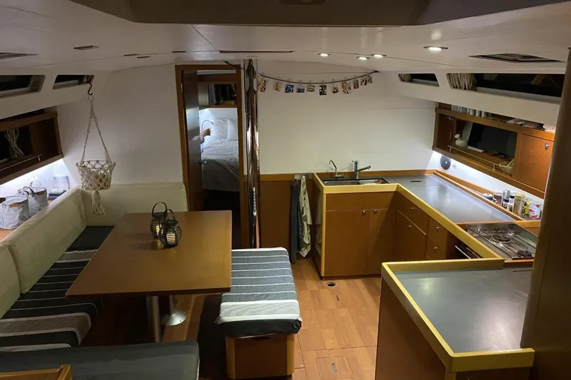  Yacht Photos Pics Interior of 2014 Beneteau Oceanis 48 yacht with modern kitchen and cozy dining area.