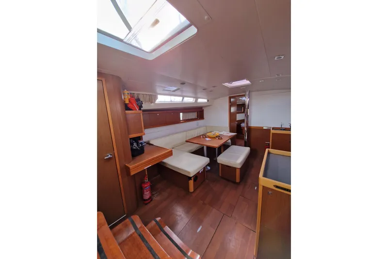  Yacht Photos Pics Interior of 2014 Beneteau Oceanis 48 yacht with dining area and wooden finish.