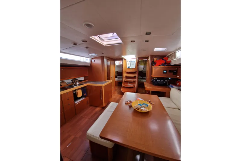  Yacht Photos Pics Interior of 2014 Beneteau Oceanis 48 yacht, featuring a cozy dining area and modern kitchen.
