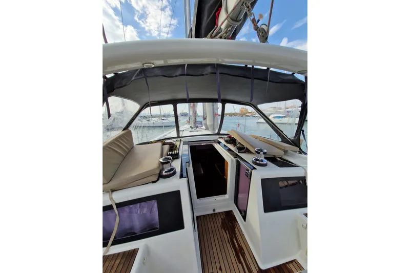  Yacht Photos Pics 2014 Beneteau Oceanis 48 yacht cockpit with seating and winches, docked at marina.