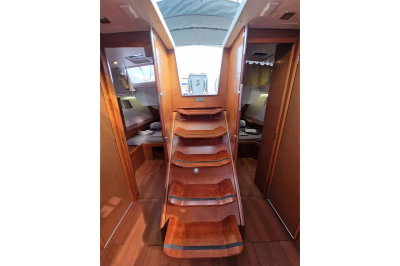  Yacht Photos Pics Interior of 2014 Beneteau Oceanis 48 yacht with wooden stairs and cozy cabins.