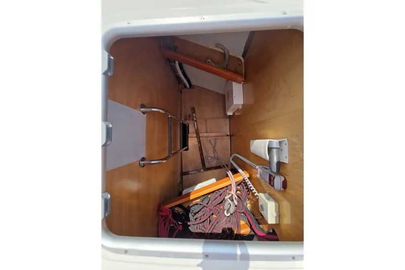  Yacht Photos Pics Storage compartment of 2014 Beneteau Oceanis 48 sailboat with equipment and ladder.