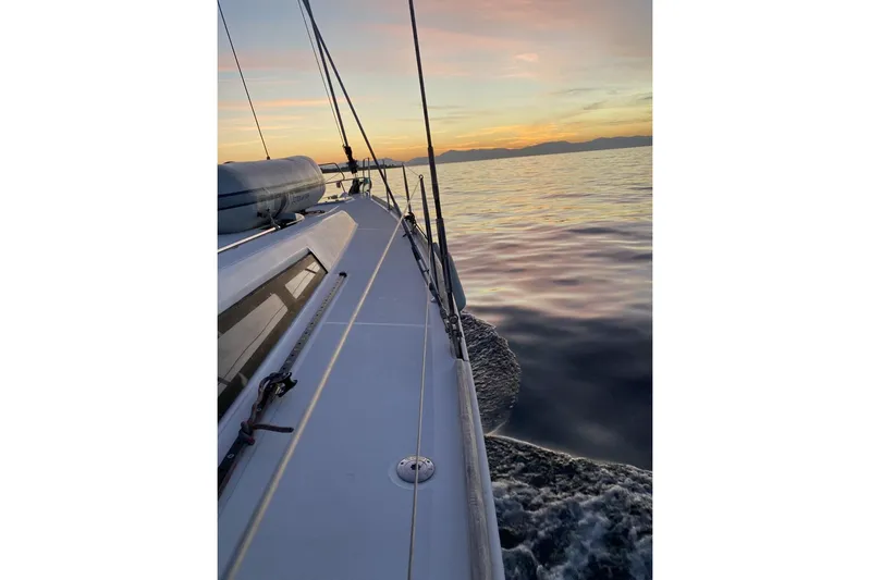  Yacht Photos Pics Sailing on a 2014 Beneteau Oceanis 48 at sunset, calm waters.