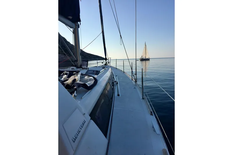  Yacht Photos Pics Sailing on a 2014 Beneteau Oceanis 48 yacht, calm sea, distant sailboat.
