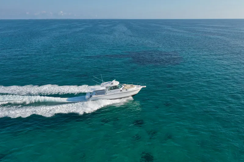 Mama Lucia Yacht Photos Pics 2017 Pursuit 385 Offshore boat cruising on clear blue ocean waters.