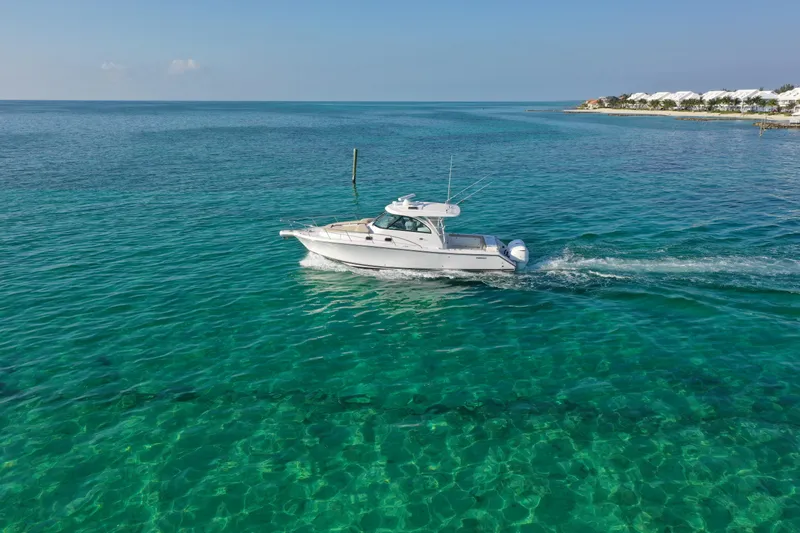 Mama Lucia Yacht Photos Pics 2017 Pursuit 385 Offshore boat cruising on clear turquoise waters.
