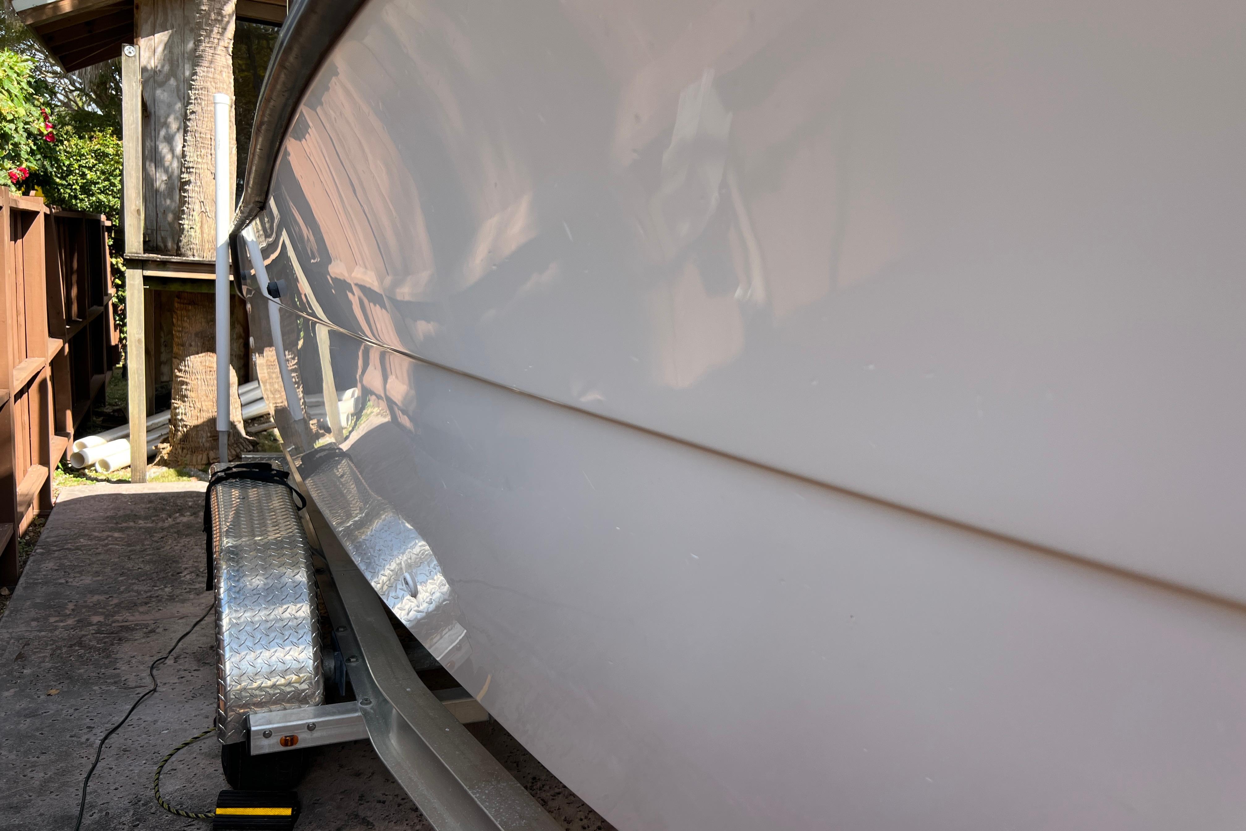 1999 Pursuit 2470 Walkaround boat on trailer, side view, outdoors.