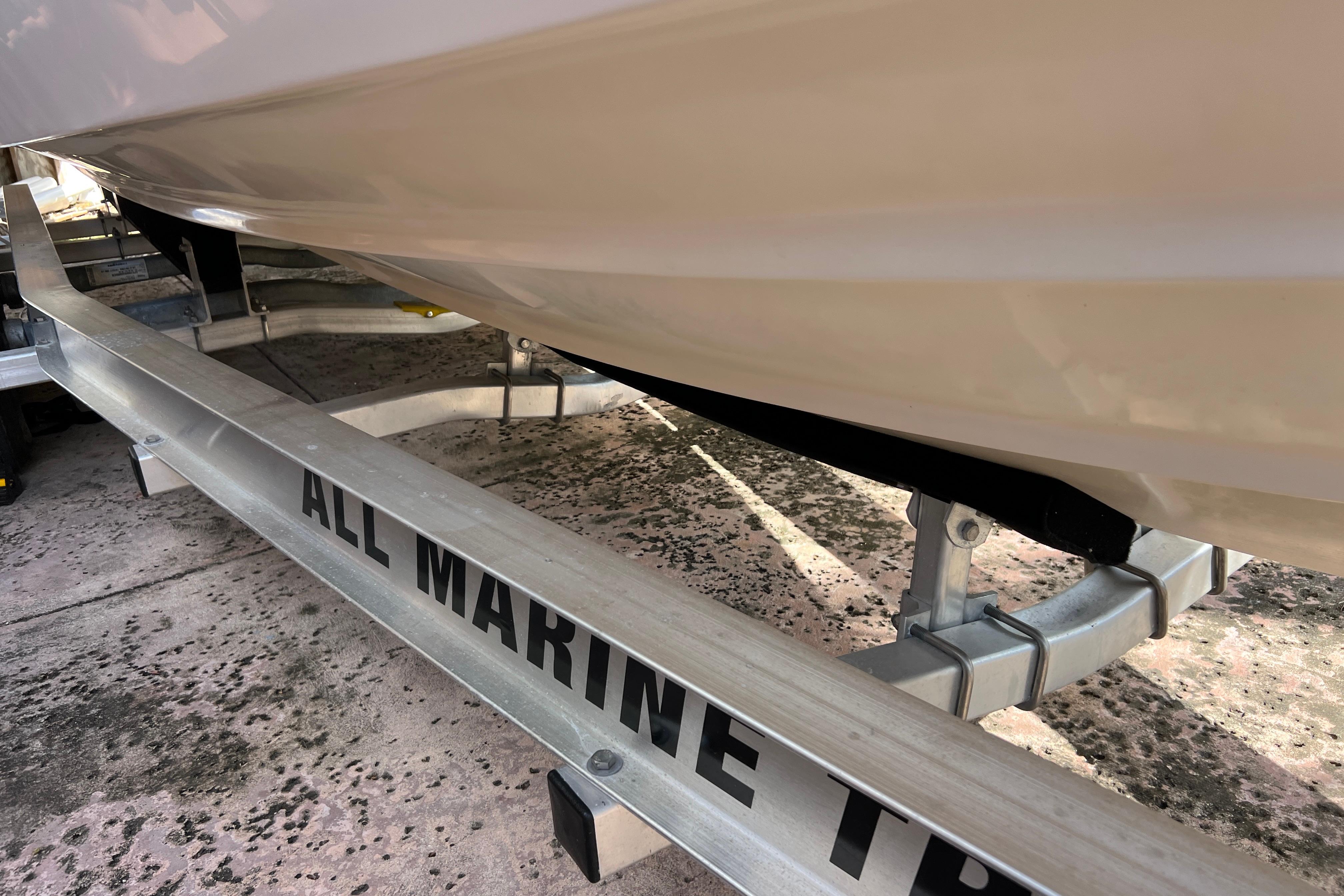 1999 Pursuit 2470 Walkaround boat on All Marine trailer, close-up view.