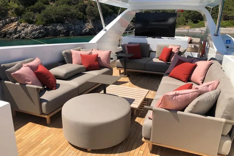 Axella Yacht Photos Pics Luxurious Crestitalia 33m yacht deck with elegant seating and scenic ocean view.