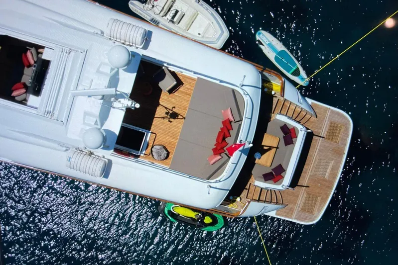 Axella Yacht Photos Pics Aerial view of 1991 Crestitalia 33m yacht with deck seating and watercraft nearby.